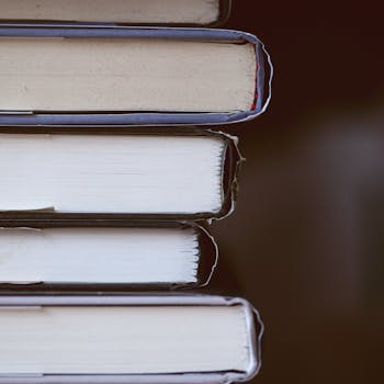 A detailed close-up of a stack of books with a literary focus, showcasing texture and alignment.