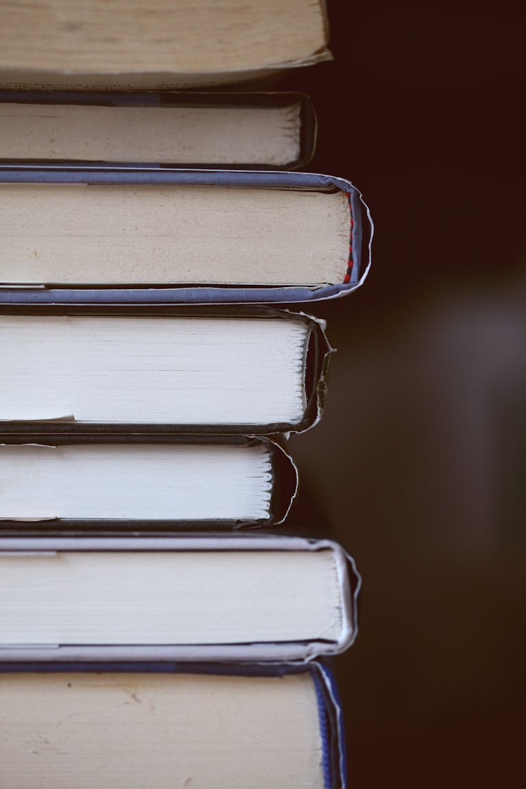 A detailed close-up of a stack of books with a literary focus, showcasing texture and alignment.